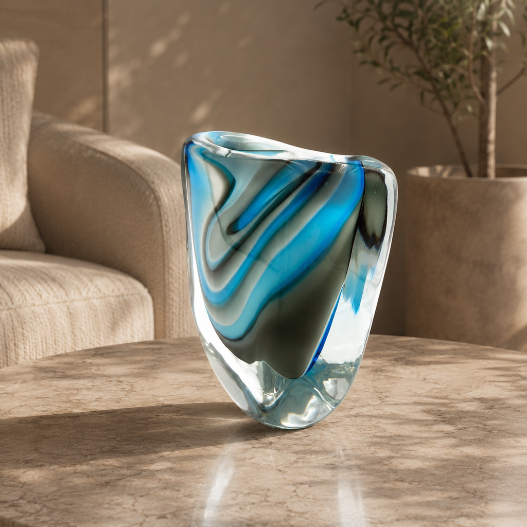 Glass vase with blue and green swirls on a wooden table