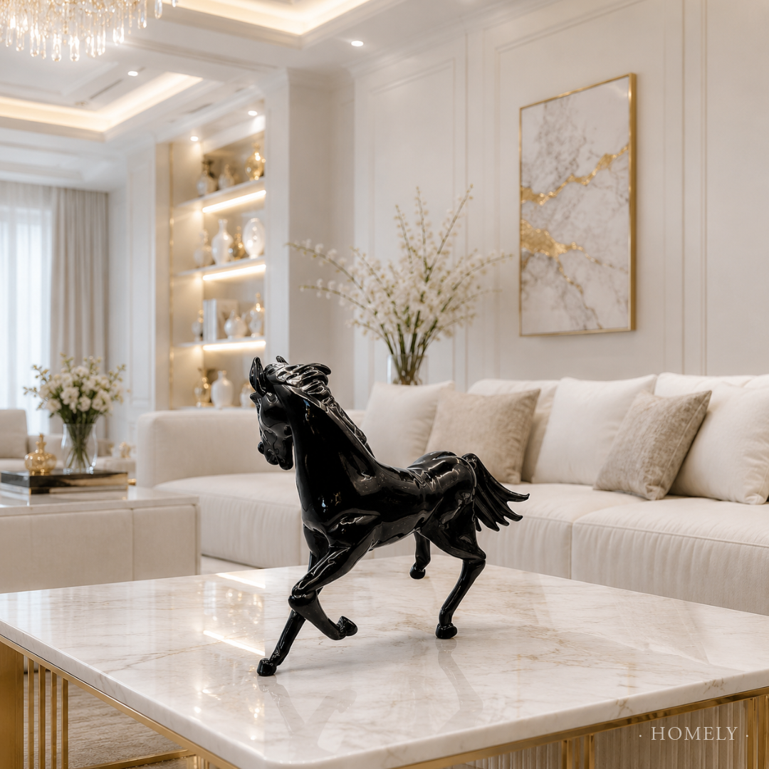 Decorative black horse sculpture on a marble coffee table in a stylish living room.