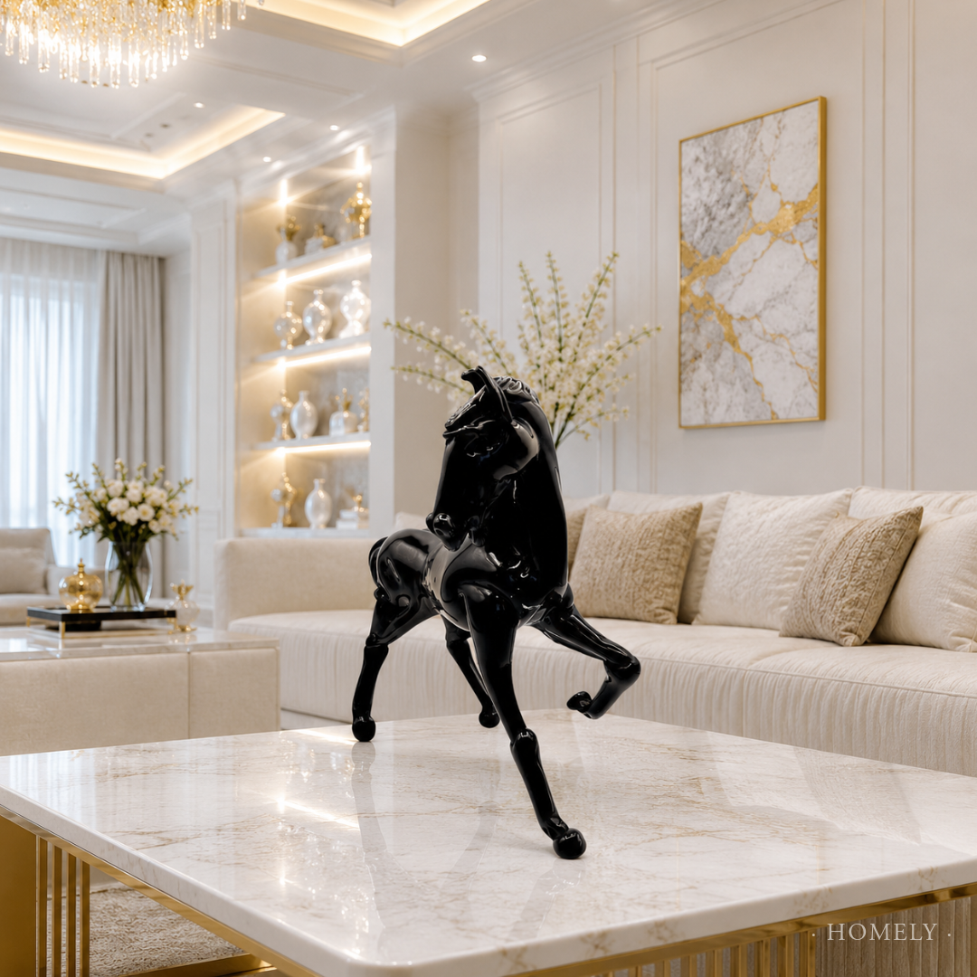 Decorative black horse sculpture on a marble coffee table in a stylish living room.