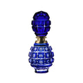 Blue glass bottle with intricate design on a white background