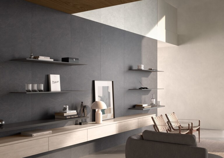 Modern living room with gray walls, shelves, and a sofa.