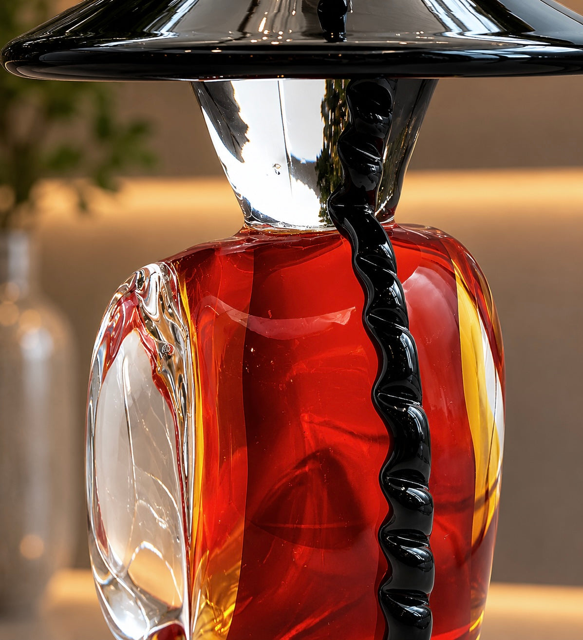 Decorative glass bottle with a black cap on a blurred background