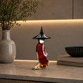Decorative glass bottle with a black cap on a counter