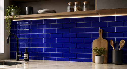 Kitchen with blue tiled wall and wooden cutting boards.
