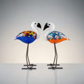 Two colorful flamingo-shaped lamps on a plain background