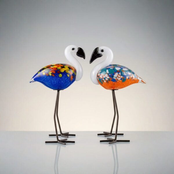 Two colorful flamingo-shaped lamps on a plain background