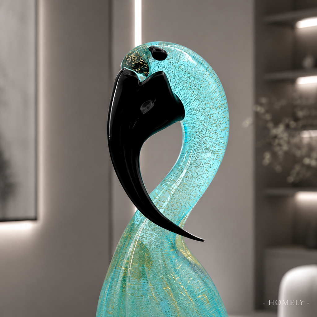 Decorative glass sculpture with a black and turquoise design in a modern interior setting.