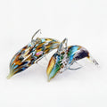 Two glass dolphins with multicolored swirl patterns on a white background