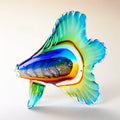 Colorful glass fish sculpture on a light background