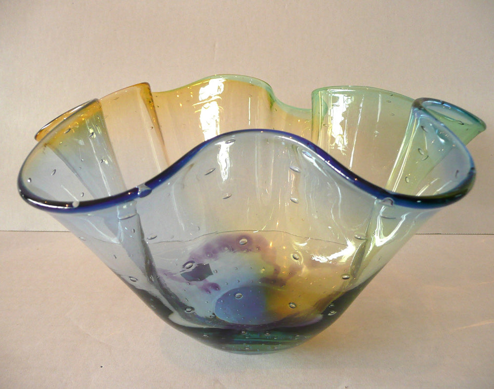 Multicolored glass bowl on a plain background