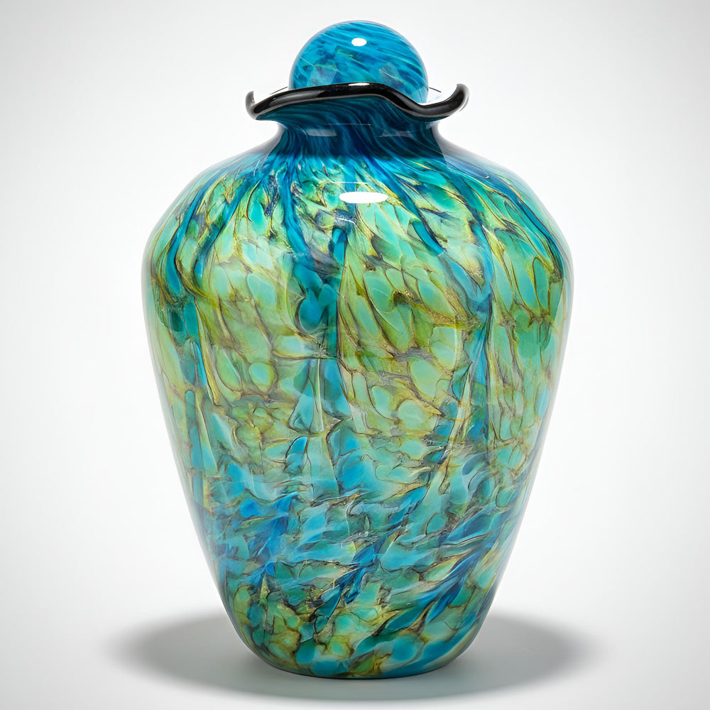 Decorative glass vase with blue and green marbled pattern on a white background