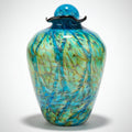 Decorative glass vase with blue and green marbled pattern on a white background