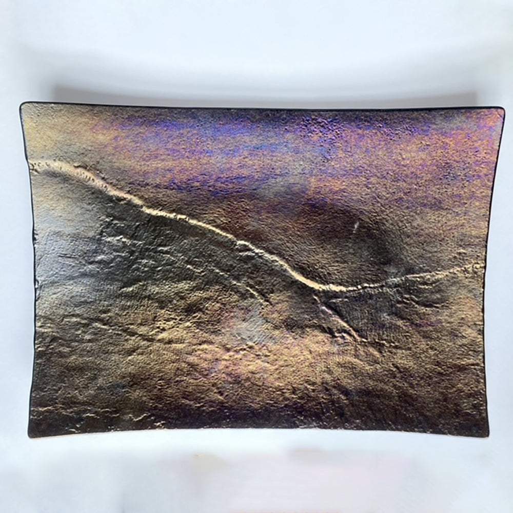 Textured rectangular object with a gradient of colors on a white background
