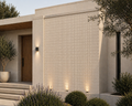 Modern house exterior with tiled wall and wooden door