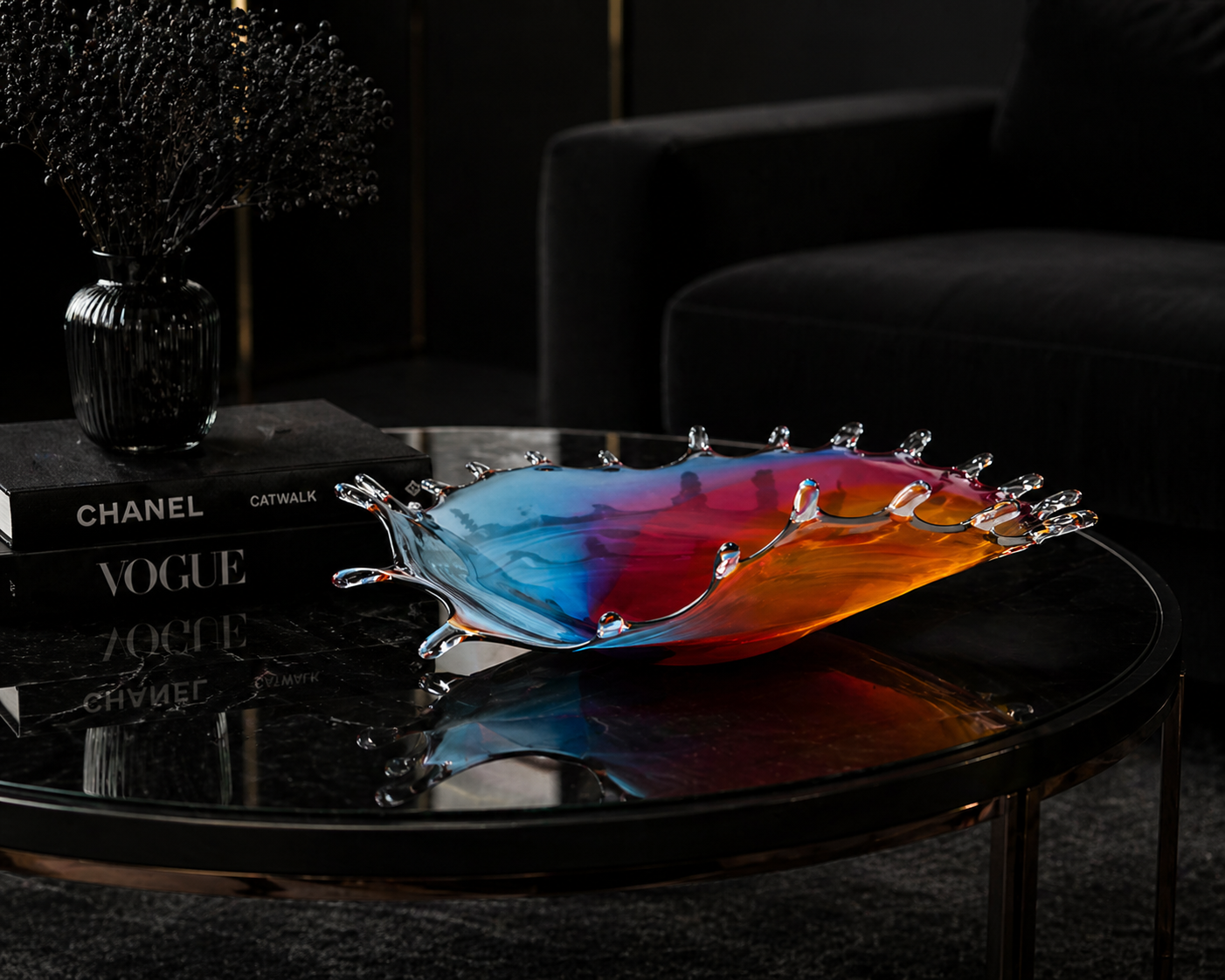 Colorful glass dish on a dark surface with books and a vase in the background