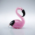 Pink glass flamingo figure on a light gray background
