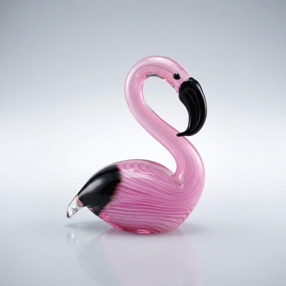 Pink glass flamingo figure on a light gray background