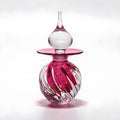 Glass vase with pink and white design on a white background