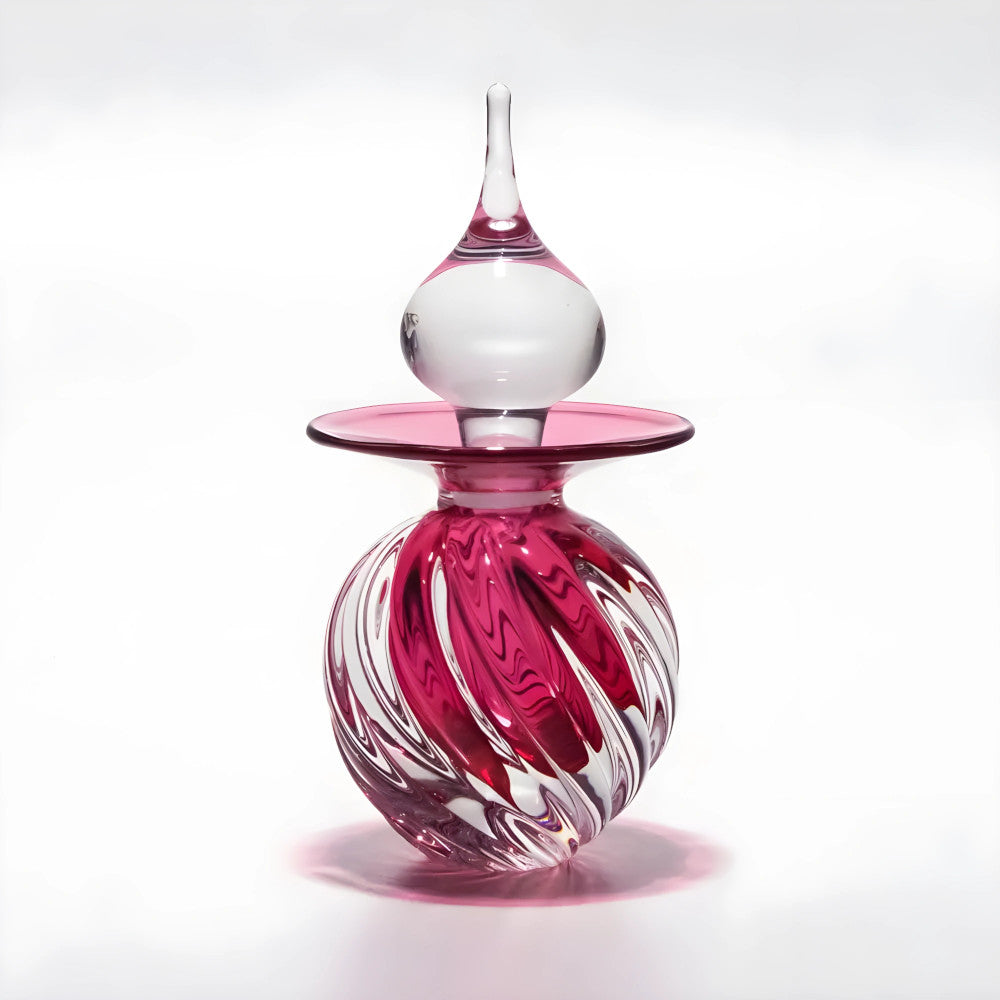 Glass vase with pink and white design on a white background