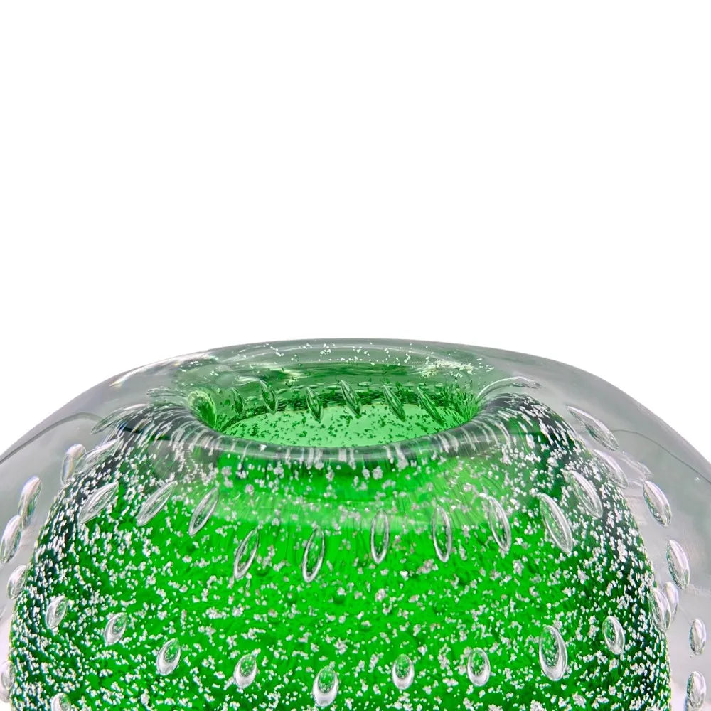 Green glass vase with bubble texture on a white background